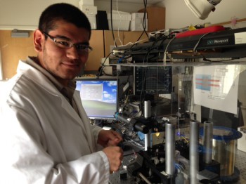 Martin Sanchez prepares optical fiber for tapering in Dr. Ertan Salik's lab.